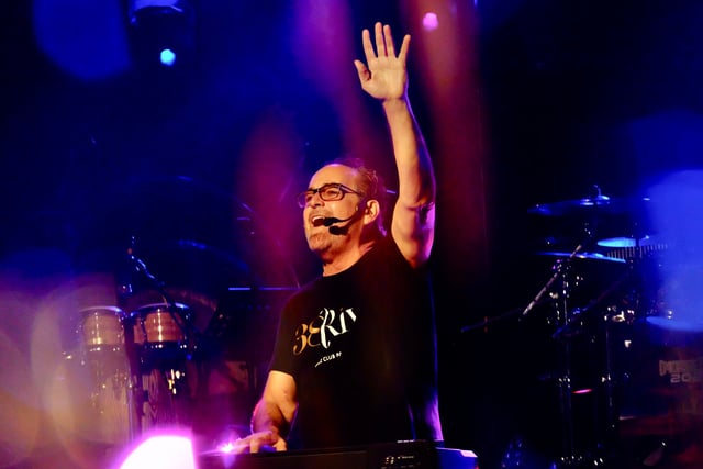 Neal Morse raising his arm on stage in blue and purple haze during Morsefest 2024 London, England